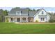 Charming two-story home featuring a landscaped front yard and inviting covered porch at 20 Tuscany Dr, Mansfield, GA 30055