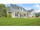 Inviting front porch with rocking chairs and an American flag on a well-manicured lawn at 20 Tuscany Dr, Mansfield, GA 30055