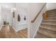 Entryway with coat rack and stairs, featuring hardwood floors and neutral paint at 20 Tuscany Dr, Mansfield, GA 30055
