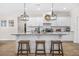 Bright kitchen boasts an island, stainless appliances, and modern light fixtures at 20 Tuscany Dr, Mansfield, GA 30055