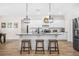 Modern kitchen features granite counters, stainless appliances, and large center island with barstool seating at 20 Tuscany Dr, Mansfield, GA 30055
