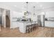 Spacious kitchen features an island, stainless appliances, and convenient access to staircase at 20 Tuscany Dr, Mansfield, GA 30055