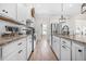 Modern kitchen featuring white cabinetry, granite countertops, stainless steel appliances, and wood floors at 20 Tuscany Dr, Mansfield, GA 30055