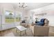 Bright living room with large windows, hardwood floors, comfortable seating, and views of the outdoors at 20 Tuscany Dr, Mansfield, GA 30055