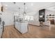 Bright open-concept living space featuring kitchen island, fireplace, and seamless flow at 20 Tuscany Dr, Mansfield, GA 30055