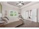 Spacious main bedroom with tray ceiling, large window, and a view into the ensuite bathroom at 20 Tuscany Dr, Mansfield, GA 30055