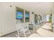Covered front porch with rocking chairs perfect for relaxing and enjoying the view at 20 Tuscany Dr, Mansfield, GA 30055
