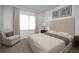 Bright bedroom features a comfortable chair, framed wall art, and a plush carpet at 206 Silverton Dr, Dacula, GA 30019