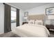 The bedroom is a peaceful retreat with a tufted headboard and soft lighting at 206 Silverton Dr, Dacula, GA 30019