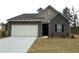 Charming brick home with a two-car garage and well-maintained front yard at 206 Silverton Dr, Dacula, GA 30019