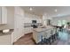 Modern kitchen with white cabinets, granite countertops, and a stylish island with seating at 206 Silverton Dr, Dacula, GA 30019