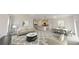 Bright, open-concept living room with a large rug, dining area, and modern decor at 206 Silverton Dr, Dacula, GA 30019
