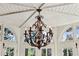 Close up of an ornate wrought iron chandelier in a room filled with windows at 41 Palisades Ne Rd, Atlanta, GA 30309