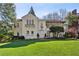 Elegant stucco home with manicured lawn, balcony, and classic architectural details at 41 Palisades Ne Rd, Atlanta, GA 30309