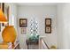 Hallway with white walls and multiple framed pictures and potted plants at 41 Palisades Ne Rd, Atlanta, GA 30309