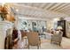 Cozy living room featuring fireplace, exposed beam ceiling, and ample seating at 41 Palisades Ne Rd, Atlanta, GA 30309