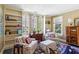 Cozy living room featuring built-in bookshelves, natural light, and comfortable chairs at 41 Palisades Ne Rd, Atlanta, GA 30309