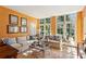 Inviting living room featuring neutral sofas, a glass coffee table, and orange walls with framed artwork at 41 Palisades Ne Rd, Atlanta, GA 30309
