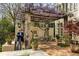 Outdoor patio featuring a vine-covered pergola, dining area, and shade at 41 Palisades Ne Rd, Atlanta, GA 30309