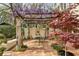 Beautiful outdoor patio featuring a vine-covered pergola and dining area at 41 Palisades Ne Rd, Atlanta, GA 30309