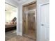 Bathroom shower with tiled walls and door, adjacent to the main bedroom at 4845 Josie Way, Acworth, GA 30101