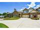 Beautiful brick home with well-manicured lawn, flower beds, and a concrete driveway leading to attached garages at 4845 Josie Way, Acworth, GA 30101