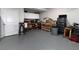 Spacious garage with ample storage, workbench, and epoxy flooring for organization and functionality at 4845 Josie Way, Acworth, GA 30101