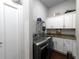 Modern laundry room with granite counters, upper cabinets, and modern washer/dryer at 4845 Josie Way, Acworth, GA 30101