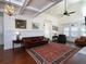Bright living room features a coffered ceiling, hardwood floors, large windows, and ample seating at 4845 Josie Way, Acworth, GA 30101