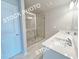 Bathroom with double sink vanity, tile flooring, and glass shower at 1367 Fern Ridge Ct # 31, Norcross, GA 30093