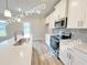 Modern kitchen with white cabinets, tile backsplash, and stainless steel appliances at 1367 Fern Ridge Ct # 31, Norcross, GA 30093