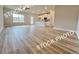Open-concept living space with wood-look floors, kitchen, and eat-in kitchen island at 1367 Fern Ridge Ct # 31, Norcross, GA 30093
