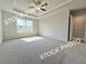Bright main bedroom featuring a tray ceiling, ceiling fan, and a view at 1367 Fern Ridge Ct # 31, Norcross, GA 30093