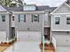 Charming townhome featuring a gray brick facade, attached garage, and well-maintained landscaping at 1387 Fern Ridge Ct # 33, Norcross, GA 30093