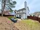 Backyard featuring artificial turf, patio, a privacy fence, and ample space for outdoor activities at 2168 Berryhill Se Cir, Smyrna, GA 30082
