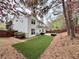 Lovely backyard with artificial turf, a privacy fence, and mature trees for outdoor enjoyment at 2168 Berryhill Se Cir, Smyrna, GA 30082