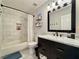 Well-lit bathroom featuring marble tile, a dark vanity, and modern fixtures for a clean and stylish look at 2168 Berryhill Se Cir, Smyrna, GA 30082