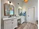 Elegant bathroom featuring double sinks, modern fixtures, stylish mirrors, and wood-look floors at 2168 Berryhill Se Cir, Smyrna, GA 30082