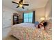 Inviting bedroom featuring a floral patterned bed, ceiling fan and natural light from the window at 2168 Berryhill Se Cir, Smyrna, GA 30082