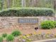 Stone community welcome sign for Paces Lake, surrounded by vibrant floral landscaping at 2168 Berryhill Se Cir, Smyrna, GA 30082