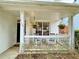 Inviting front porch featuring white railing, comfortable seating, and hanging floral arrangements at 2168 Berryhill Se Cir, Smyrna, GA 30082