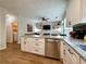 Open kitchen layout with a view into the living room, stainless steel appliances and island with granite countertops at 2168 Berryhill Se Cir, Smyrna, GA 30082