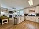 Modern kitchen with stainless steel appliances, white cabinets and granite countertops; adjoins living room with fireplace at 2168 Berryhill Se Cir, Smyrna, GA 30082