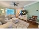 Inviting living room with sofas, a ceiling fan, and natural light creates a warm and welcoming atmosphere at 2168 Berryhill Se Cir, Smyrna, GA 30082