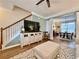 Comfortable living room featuring a modern TV, open staircase, and views into the dining area at 2168 Berryhill Se Cir, Smyrna, GA 30082