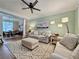 Cozy living room with a modern ceiling fan, plush sofas, decorative rug, and plenty of natural light at 2168 Berryhill Se Cir, Smyrna, GA 30082