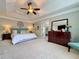 Bright main bedroom with a decorative tray ceiling, neutral paint, and plush carpet flooring at 2168 Berryhill Se Cir, Smyrna, GA 30082