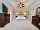Spacious main bedroom featuring a tray ceiling, carpet, and dual dressers at 2168 Berryhill Se Cir, Smyrna, GA 30082
