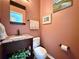 Charming powder room with granite countertop, decorative mirror, and neutral colored walls at 2168 Berryhill Se Cir, Smyrna, GA 30082