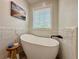 Elegant freestanding bathtub with modern fixtures and decorative tile surround at 2168 Berryhill Se Cir, Smyrna, GA 30082